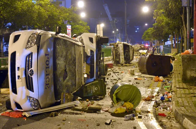 The wrecks of several police cars. Aftermath of the riot in Little India, Race Course Road and Buffalo Road, 9 December 2013. A riot involving almost 400 people broke out in Little India along Race Course Road. The riot is believed to have started after a fatal traffic accident. (Photo by Alphonsus Chern)