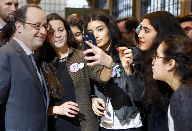 French President Francois Hollande makes a selfie with participants during a visit at a forum entitled “La France s'engage” dedicated to associations for social and solidarity projects of education, employment, culture, environment and sports in Paris, France, January 15, 2017. (Photo by Francois Mori/Reuters)