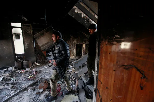 Members of the Iraqi forces inspect a hospital damaged by clashes during a battle between Iraqi forces and Islamic State militants in the Wahda district of eastern Mosul, Iraq, January 8, 2017. (Photo by Alaa Al-Marjani/Reuters)