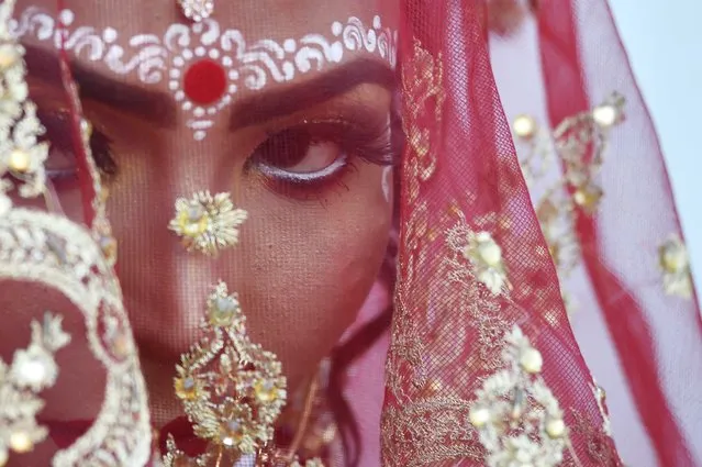 A Pakistani Hindu bride attends a mass marriage ceremony in Karachi, Pakistan, 07 January 2024. The Pakistan Hindu Council organized the mass wedding ceremony for 122 Hindu couples belonging to poorer classes. (Photo by Shahzaib Akber/EPA/EFE)