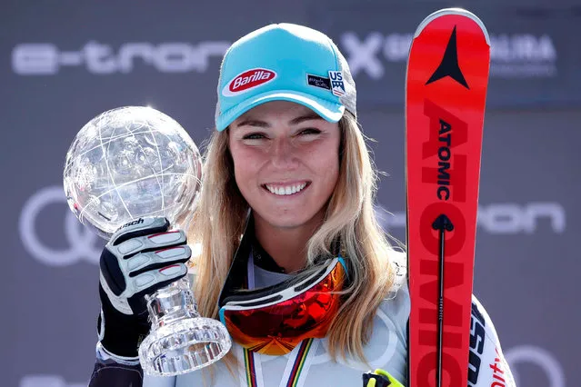 Winner of the overall FIS Alpine ski slalom US Mikaela Shiffrin celebrates with the crystal globe trophy during the podium ceremony after competing in the Women's slalom race during the FIS Alpine ski world cup championship on March 16, 2019, in Grandvalira Soldeu – El Tarter, in Andorra. (Photo by Albert Gea/Reuters)