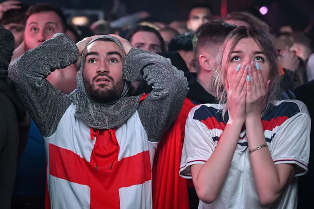 England fans react to France's second goal as they watch a screen showing the 2022 World Cup quarter-final football match between England and France, at Depot Mayfield in Manchester on December 10, 2022. (Photo by Oli Scarff/AFP Photo)