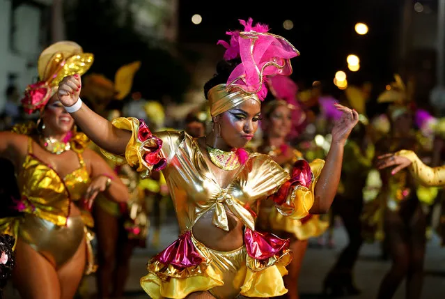 Members of a comparsa, a Uruguayan carnival group, dance during the Llamadas parade, a street fiesta with tradtional Afro-Uruguayan roots in Montevideo February 10, 2017. (Photo by Andres Stapff/Reuters)