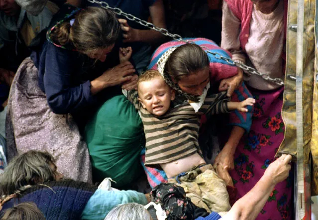 Bosnian Muslim women, refugees from Srebrenica, pull a child onto a truck before being transported from the eastern Bosnian village of Potocari, July 1995. Radovan Karadzic is the highest-ranking person to face a reckoning before the U.N. tribunal in The Hague over a war two decades ago in which 100,000 people were killed as rival armies carved Bosnia up along ethnic lines that largely survive today. (Photo by Reuters)