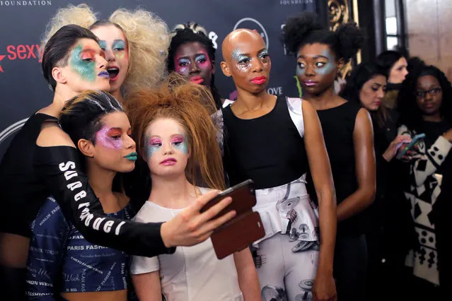 Australian model and designer Madeline Stuart, who has Down syndrome, poses for a selfie with models backstage before presenting creations from her label 21 Reasons Why By Madeline Stuart during New York Fashion Week in Manhattan, New York, U.S., February 12, 2017. (Photo by Andrew Kelly/Reuters)