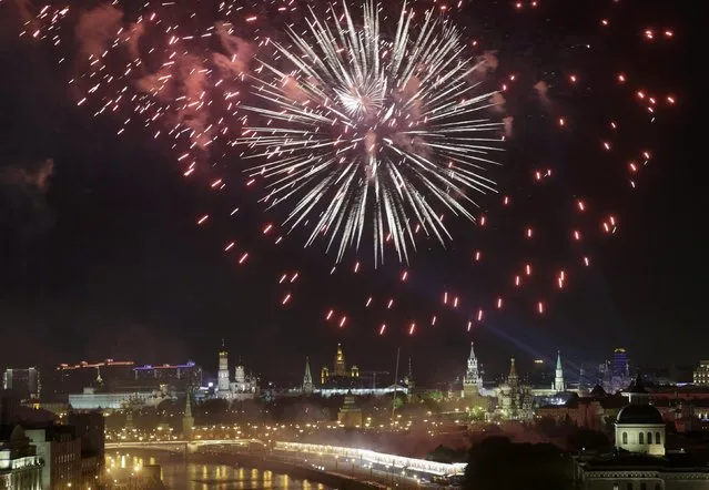 Fireworks explode over the Moskva river, with Kremlin seen on the background, during the Victory Day celebrations in Moscow, Russia, May 9, 2015. (Photo by Tatyana Makeyeva/Reuters)