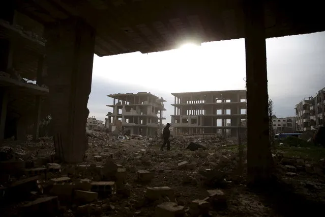 A man walks on the rubble of damaged buildings in the rebel-controlled area of Jobar, a suburb of Damascus, Syria March 2, 2016. (Photo by Bassam Khabieh/Reuters)