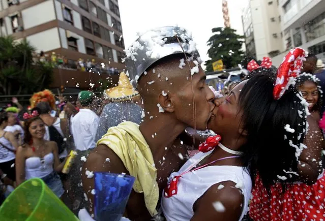Revelers kiss during the Banda de Ipanema Carnival parade in Rio de Janeiro, Brazil, Saturday, March 1, 2014. Streets across Brazil have been swamped with Carnival revelers, with the largest parties attracting more than 1 million merrymakers. (Photo by Silvia Izquierdo/AP Photo)