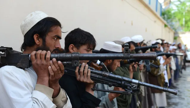 Taliban fighters hold their weapons before surrendering them to Afghan authorities in Jalalabad, east of Kabul, Afghanistan, Sunday, March 27, 2016. Around 53 Taliban fighters laid down their weapons at a ceremony, as part of a peace-reconciliation program. (Photo by Mohammad Anwar Danishyar/AP Photo)