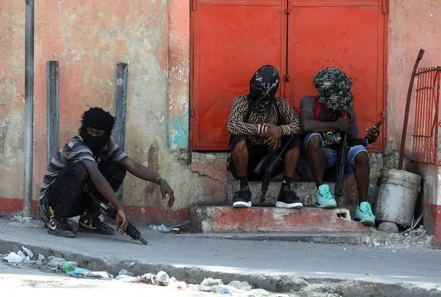 Gang members sit together after former police officer Jimmy “Barbecue” Cherizier, leader of an alliance of armed groups, addressed the media, in Port-au-Prince, Haiti on March 11, 2024. (Photo by Ralph Tedy Erol/Reuters)