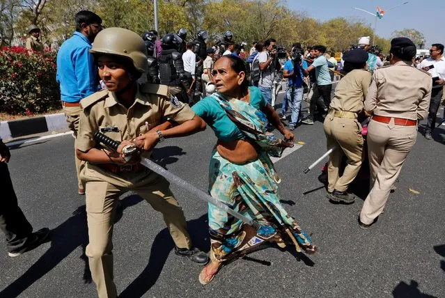 Police detain a demonstrator during a protest organised by India's main opposition Congress party against what the demonstrators say was the rape of a woman in Gujarat’s Naliya town in Gandhinagar, India, February 20, 2017. (Photo by Amit Dave/Reuters)