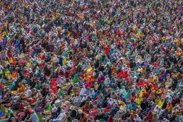 Muslim faithful gather as the wait for the special morning prayer to start the Eid al-Fitr festival, marking the end of the holy month of Ramadan, at the Kigali Pele Stadium in Kigali's Muslim quarter of Nyamirambo, on April 10, 2024. (Photo by Luis Tato/AFP Photo)