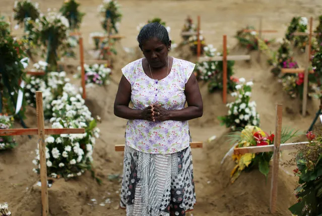 A woman reacts during mass burials near St. Sebastian church in Negombo, Sri Lanka on April 28, 2019. (Photo by Athit Perawongmetha/Reuters)