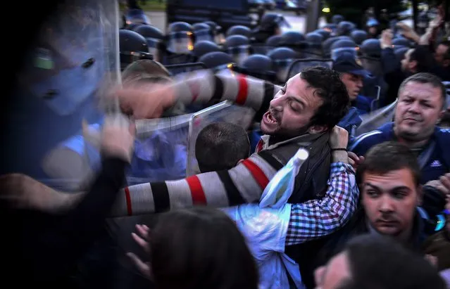 Protesters are pushing with the riot police, during the protest dubbed “colorful revolution” against Macedonian President Ivanov's decision on wiretapping amnesty, in Skopje, The Former Yogoslav Republic of Macedonia, 21 April 2016. Ivanov on 12 April decided to abolish all judicial cases related to the big wire-tapping scandal that brought the country to early general elections scheduled for 05 June.  (Photo by Nake Batev/EPA)