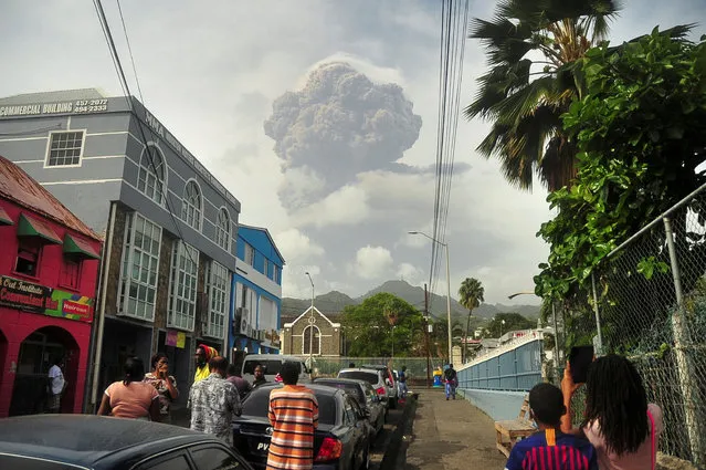 Ash rises into the air as La Soufriere volcano erupts on the eastern Caribbean island of St. Vincent, seen from Chateaubelair, Friday, April 9, 2021. (Photo by Orvil Samuel/AP Photo)
