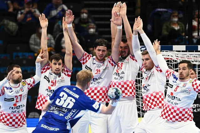 Iceland's Elvar Asgeirsson (3rd L) tries to score in the last seconds of the game during the Men's European Handball Championship match group I between Iceland and Croatia in the MVM Dome arena in Budapest, Hungary, on January 24, 2022. (Photo by Attila Kisbenedek/AFP Photo)