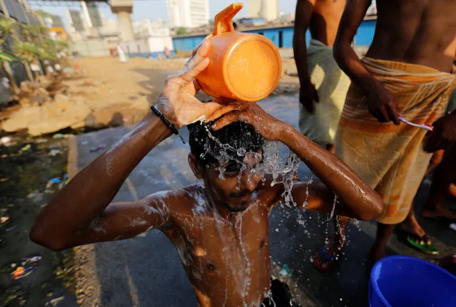 A labourer takes a bath at a communal tap in Mumbai, March 22, 2017. (Photo by Danish Siddiqui/Reuters)