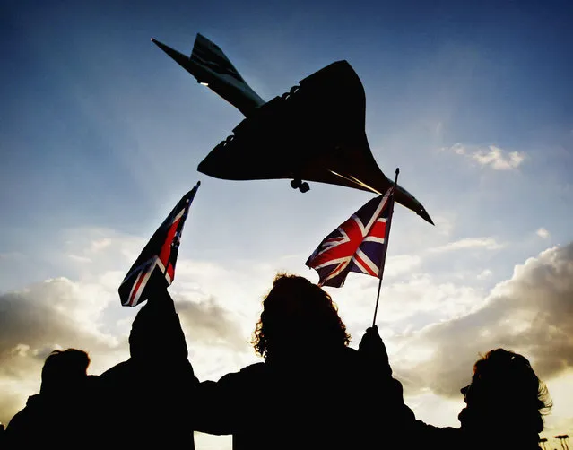 Spectators watch the last ever British Airways commercial Concorde flight touch down at Heathrow airport October 24, 2003 in London. The world's only supersonic passenger aircraft, which has been flying commercial services for 27 years, will be retired by British Airways today. (Photo by Graeme Robertson/Getty Images)
