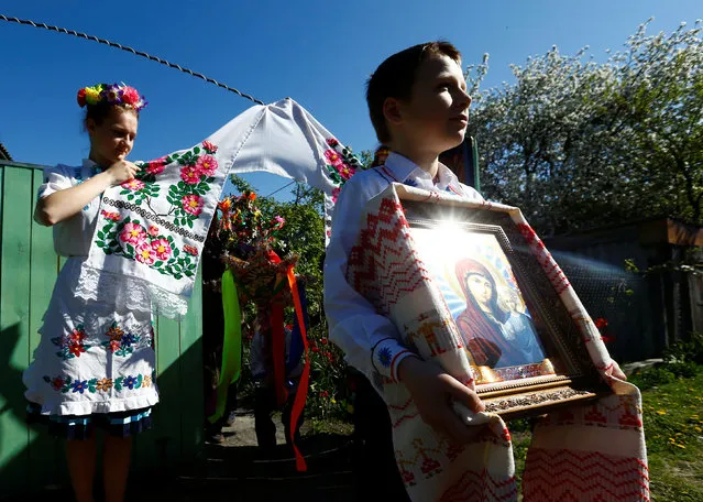 Villagers take part in a ritual celebrating the pagan god Yurya and pray for plentiful future harvests in the village of Pogost, Belarus May 6, 2016. (Photo by Vasily Fedosenko/Reuters)