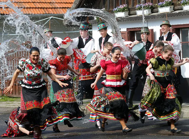Girls dressed in traditional costumes run as men throw water on them as part of Easter celebrations during a presentation to the media in Mezokovesd, Hungary, April 13, 2017. (Photo by Laszlo Balogh/Reuters)