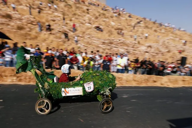 A competitor drives his homemade vehicle without an engine during the Red Bull Soapbox Race in Amman, Jordan on September 20, 2019. (Photo by Muhammad Hamed/Reuters)