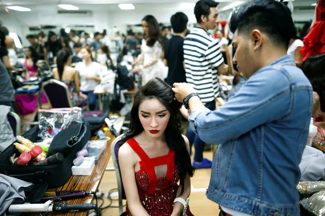 A beauty contestant prepares backstage before the final of the annual Miss Tiffany's Universe 2016 Transvestite Contest at a beach resort in Pattaya, Thailand May 13, 2016. (Photo by Athit Perawongmetha/Reuters)