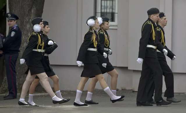 Ukrainian navy cadets march after Victory Day celebrations in Odessa, Ukraine, Friday, May 9, 2014. In the Black Sea port of Odessa, which last week was rocked by violent clashes between pro-Russian forces and supporters of the central government that left nearly 50 people died, the local governor issued an order banning public display of Russian flags. (Photo by Vadim Ghirda/AP Photo)