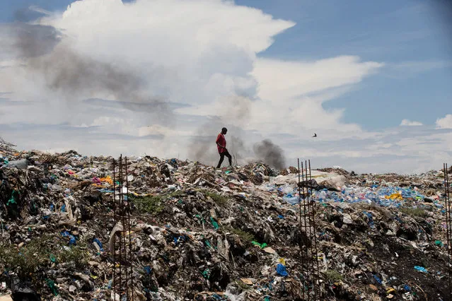 A man walks on top of a garbage dump in the city of Kisumu, Kenya April 18, 2017. (Photo by Baz Ratner/Reuters)