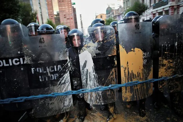 Police stand behind shields during a protest in La Paz, Bolivia on October 22, 2019. (Photo by Ueslei Marcelino/Reuters)