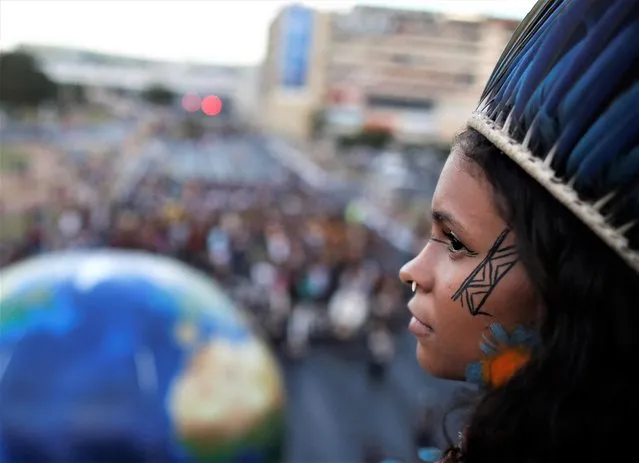 An Indigenous woman looks on during a protest against Brazil's President Jair Bolsonaro and for land demarcation in Brasilia, Brazil, April 6, 2022. (Photo by Adriano Machado/Reuters)