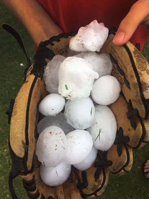 This photo provided by Stacey Valdez shows hail Valdez took in Sayre, Okla., Tuesday, May 16, 2017. Also, a tornado struck a rural area in western Oklahoma, leaving damage in its wake but no immediate reports of injuries. The storm struck a subdivision Tuesday just south of Elk City, Okla., about 110 miles west of Oklahoma City. (Photo by Stacey Valdez via AP Photo)