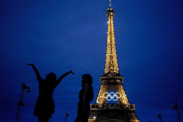 Team USA athletic trainer Amarilees Bolorin, left, poses for a selfie in front of the Eiffel Tower ahead of the 2024 Summer Olympics, in Paris, July 25, 2024. (Photo by Natacha Pisarenko/AP Photo)