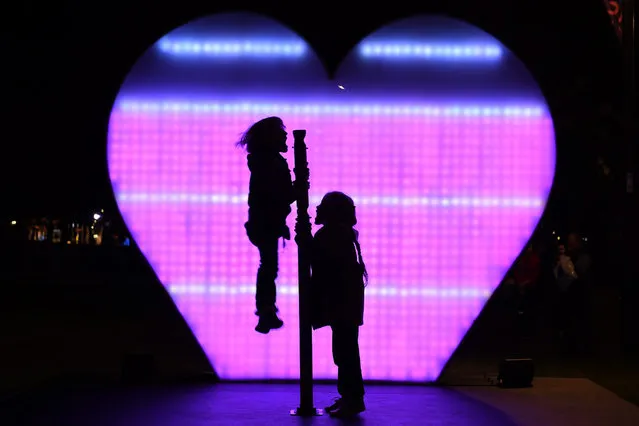 Young children shout I love you at the I Love You (AUS) installation at First Fleet Park as part of the Vivid Sydney festival of light in Sydney, Australia, 26 May 2016. Vivid Sydney runs from May 27 through to June 18 and is the largest festival of its kind in the world. (Photo by Dean Lewins/EPA)