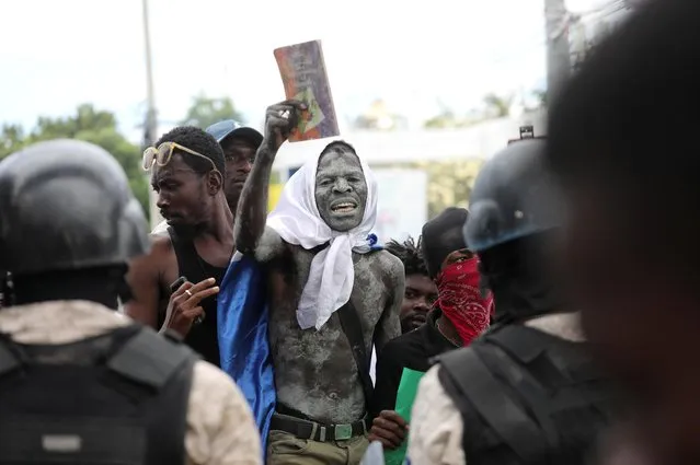 Demonstrators face police during protests demanding that the government of Prime Minister Ariel Henry do more to address gang violence including constant kidnappings, in Port-au-Prince, Haiti on March 29, 2022. (Photo by Ralph Tedy Erol/Reuters)