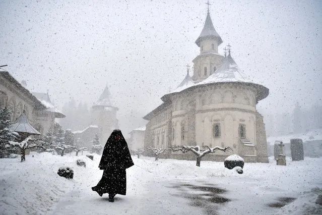 Romanian Orthodox monk, Father Mikhail, departs after the mass at the Church in Putna Monastery, Putna, Romania, March 8, 2022. During the mass, blessings were also given for Ukrainian refugees who are fleeing amid Russia's invasion. (Photo by Clodagh Kilcoyne/Reuters)