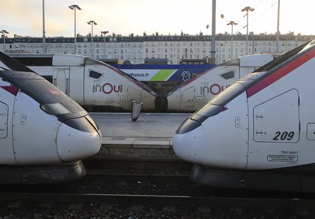 High-speed trains are pictured at Gare du Nord train station in Paris, Wednesday, December 18, 2019. With French President Emmanuel Macron under heavy pressure over his pension reform plans, government officials are meeting with employers and unions on Wednesday to consider the way forward. (Photo by Michel Euler/AP Photo)