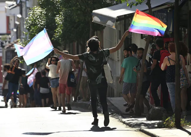 LGBTI activists disperse to avoid detention by Turkish police officers in Istanbul, Sunday, July 2, 2017. A small group of transgender rights activists has attempted to march to Istanbul's main square, carrying rainbow flags, despite the governor's ban and security precautions by police. The Istanbul governor's office banned the march late Saturday for the second year in a row, 'to preserve public order and to keep participants and tourists safe', it said. (Photo by Lefteris Pitarakis/AP Photo)