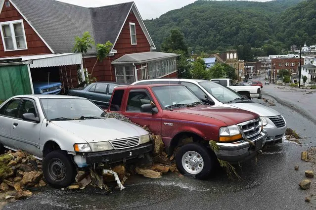 Cars and large rocks are smashed together after being carried down Oakford Avenue by flood waters in Richwood, W.Va. on Friday June 24, 2016. (Photo by Christian Tyler Randolph/Charleston Gazette-Mail via AP Photo)