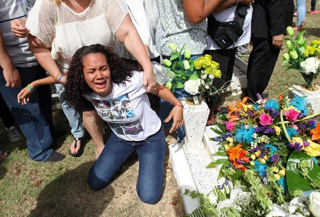 A relative of Xavier Emmanuel Serrano Rosado, one of the victims of the shooting at the Pulse night club in Orlando, reacts during his funeral in his hometown of Ponce, Puerto Rico, June 24, 2016. (Photo by Alvin Baez/Reuters)