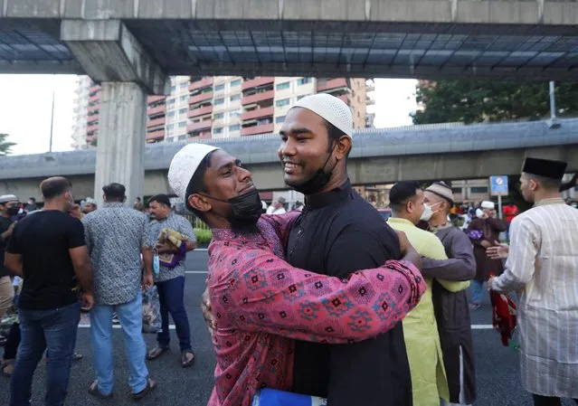 South Asia migrants embrace each other as they celebrate Eid al-Fitr, marking the end of the holy fasting month of Ramadan, in Kuala Lumpur, Malaysia, May 2, 2022. (Photo by Hasnoor Hussain/Reuters)