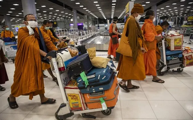 Thai monks wearing masks arrive from India at Suvarnabhumi International airport on March 04, 2020 in Bangkok, Thailand. With limited information about cases in some South East Asian countries health experts are worried that the infection could be spreading undetected throughout some parts of the region. The global mortality rate for Covid-19, is 3.4 percent. The Coronavirus has infected roughly 94,000 with 3,221 deaths. (Photo by Paula Bronstein/Getty Images)