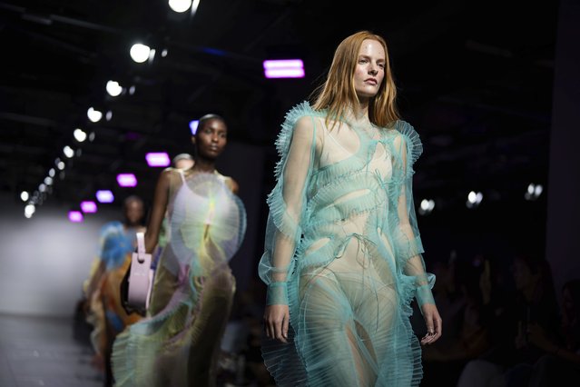 Models wear creations for the Nadia Dzyak collection on Tuesday, September 19, 2023 in London. For Ksenia Schaider and other Ukrainian designers, the fashion show must go on, despite the war in their country or precisely because of it. Schaider may have fled to the U.K. as a refugee, but her team still makes every garment in Kiev, often under incessant air raid sirens and lengthy power cuts. (Photo by Scott Garfitt/Invision/AP Photo)