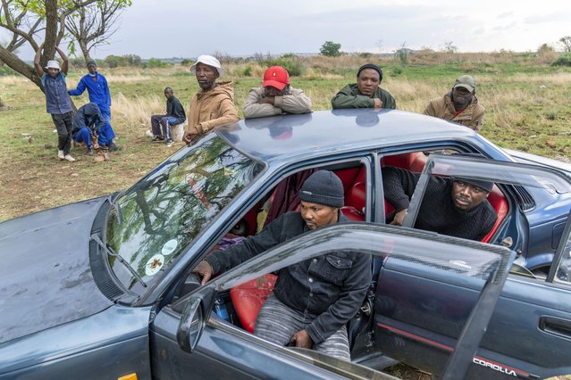 Relatives of miners and community members wait at a mine shaft where illegal miners are trapped in a disused mine in Stilfontein, South Africa, Thursday, November 14, 2024. (Photo by Jerome Delay/AP Photo)