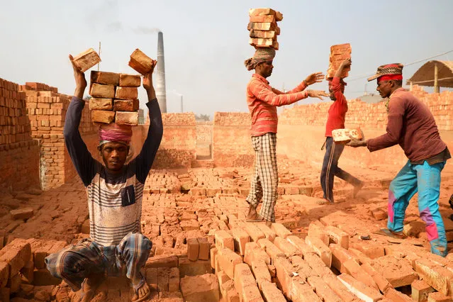 People are working in a brick kiln in Narayanganj, Bangladesh, January 8, 2020. (Photo by Mohammad Ponir Hossain/Reuters)