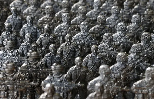 Figurines of pro-Russian separatist fighters from the collection entitled “Toy Soldiers of Novorossiya” are on display at a workshop in Moscow August 29, 2014. (Photo by Sergei Karpukhin/Reuters)