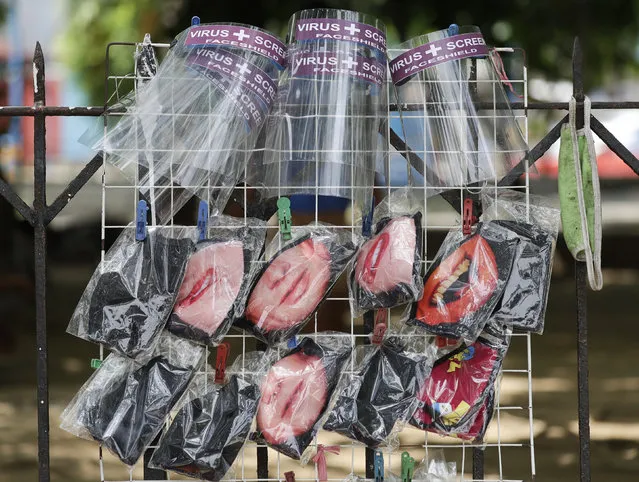 Face shields and printed masks are sold during an enhanced community quarantine to prevent the spread of the new coronavirus in Manila, Philippines on Thursday April 23, 2020. (Photo by Aaron Favila/AP Photo)