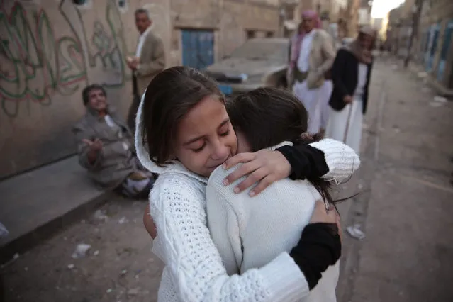 Girls react as they stand near their damaged house at the site of a Saudi-led airstrike near Yemen's Defense Ministry complex in Sanaa, Yemen, Saturday, November 11, 2017. (Photo by Hani Mohammed/AP Photo)