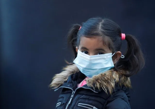 A migrant girl from the Moria camp in Lesbos waits to board a bus at Piraeus port following the coronavirus outbreak in Athens, Greece, May 4, 2020. (Photo by Goran Tomasevic/Reuters)