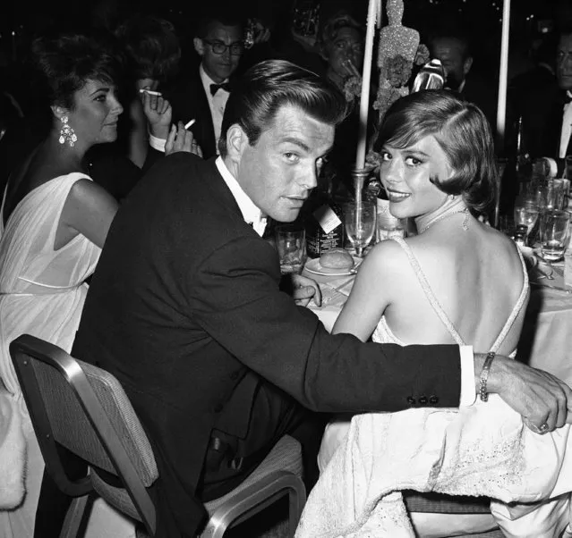 Actors Robert Wagner and wife  Natalie Wood at academy party on June 20, 1961. Elizabeth Taylor is in background left. (Photo by AP Photo/DFS)