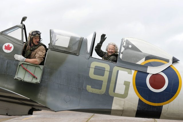 Dorothea Barron, aged 99, who was a serving Wren at the time of D-Day sits in a Spitfire with pilot Jeremy Britcher at Biggin Hill Airport in Kent, England, Tuesday, May 28, 2024. The Taxi Charity for Military Veterans took WWII veterans, including Normandy veterans, to an event at the Biggin Hill Heritage Hangar just ahead of their trip to Normandy for the D Day 80th Anniversary. (Photo by Kirsty Wigglesworth/AP Photo)